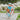 Garçon de 3 ans sur vélo Bebikeen 12 pouces bleu turquoise avec panier avant en osier naturel et casque bleu turquoise assorti.