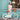 Fille portant un casque bleu turquoise Bebikeen, debout à côté de son vélo léger 16 pouces bleu turquoise avec panier en osier.