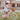 Fille de 5 ans pédale sur vélo enfant Bebikeen 16 pouces rose léger avec panier en osier, casque rose assorti, vue de profil.